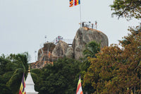 Mihintale stupa and rock formations with Buddhist flags, Sri Lanka