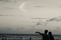 Couple silhouetted against a golden sunset on Ahangama beach, Sri Lanka